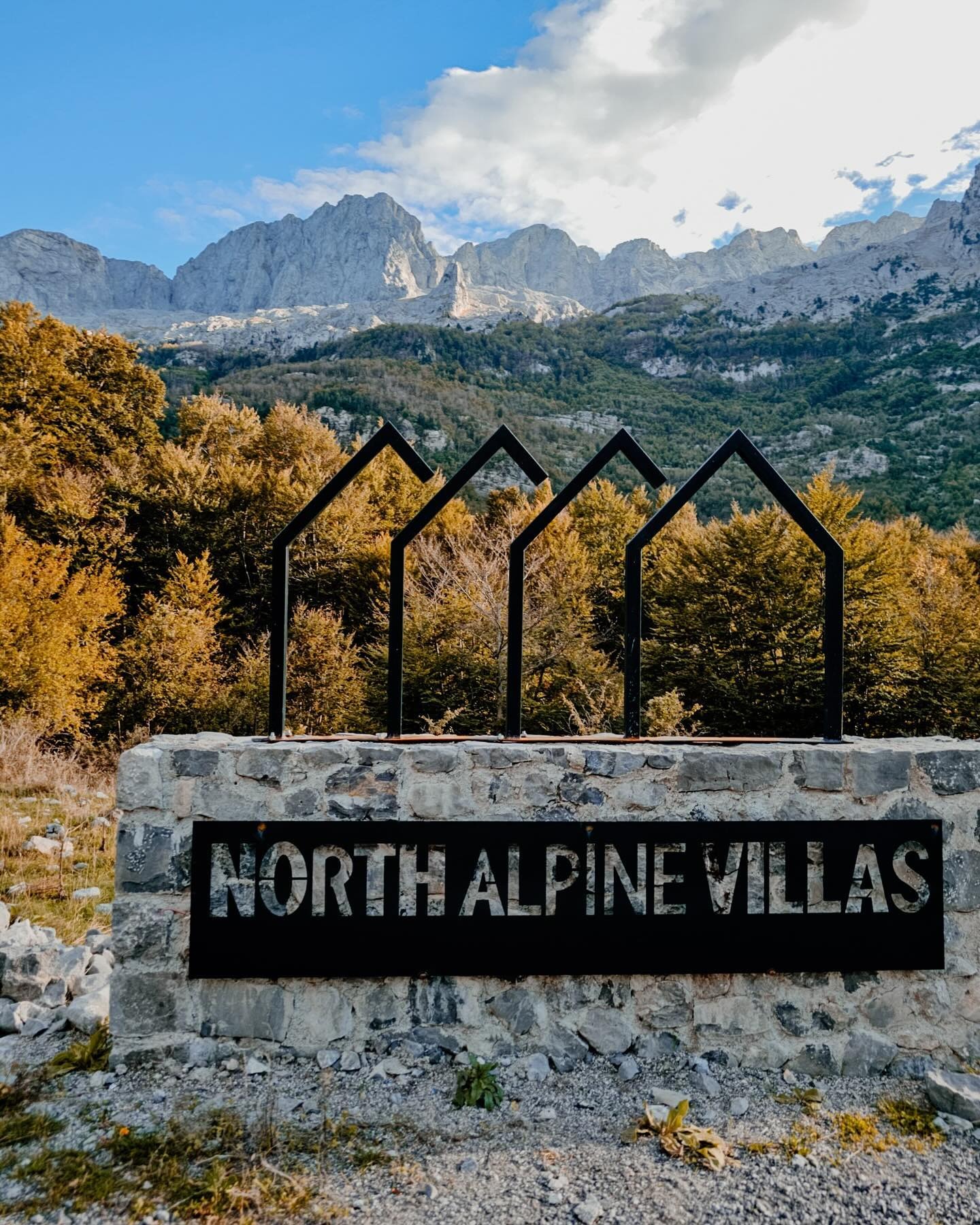 North Alpine Villas sign with the Albanian Alps beyond
